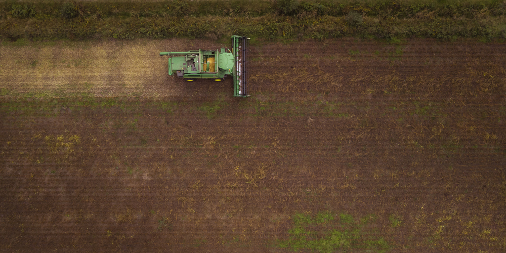 Luchtfot van akker met traktor.